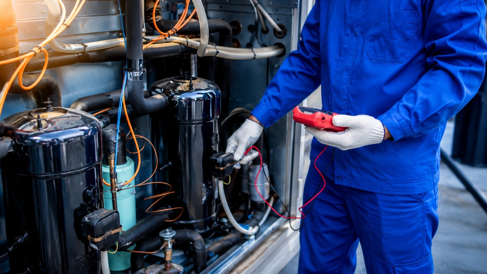 Commercial walk-in cooler with technician servicing the condenser unit